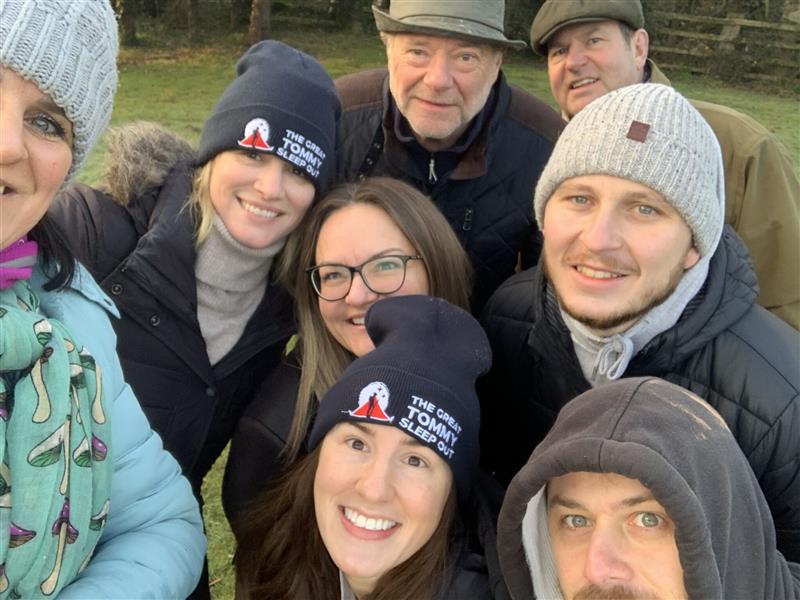 A group of friends taking a selfie wearing The Great Tommy Sleep Out Beanies 